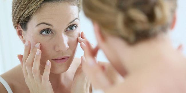 woman-looking-skin-mirror