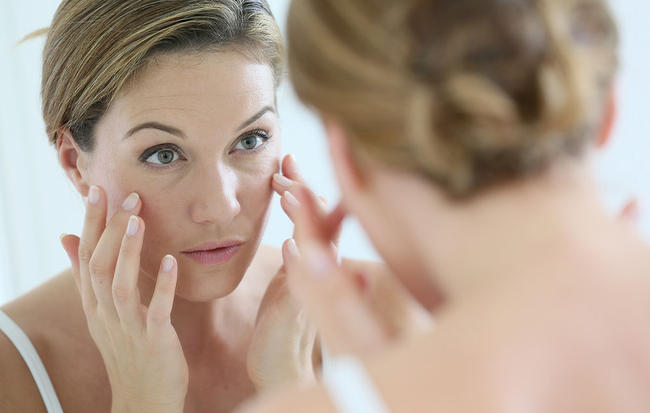 woman-looking-skin-mirror